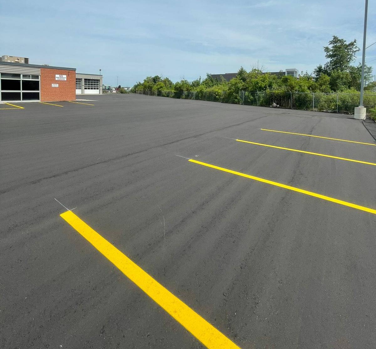 Freshly paved and sealed commercial parking lot in Saskatchewan